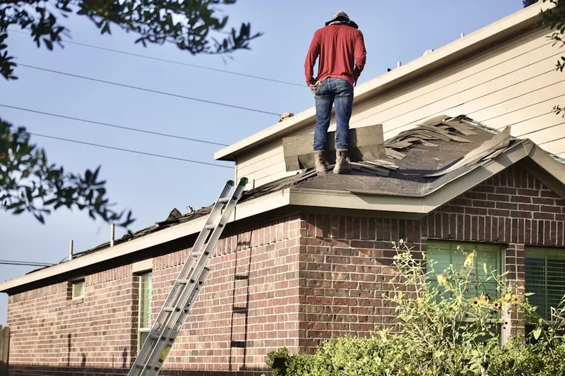 Professional roofer working on a residential roof in Pegville